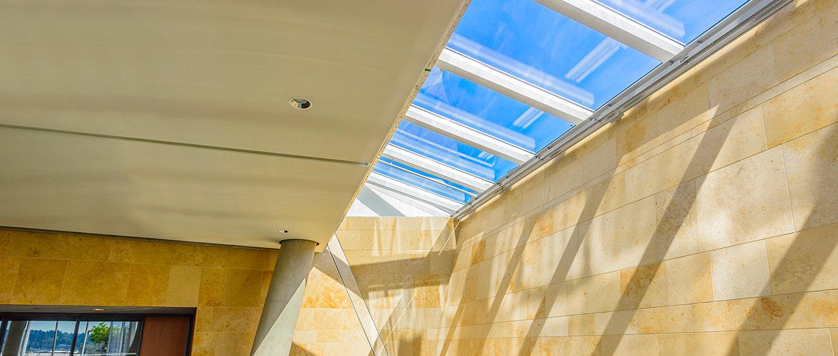 Beige-yellow marble interior lit up by a long rectangular sun roof window.