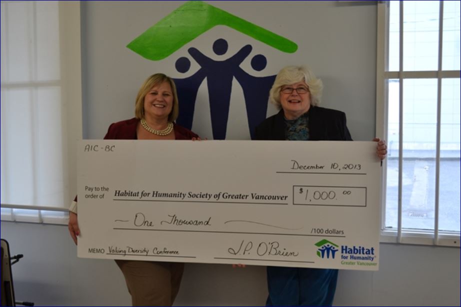 CAE Executive Director Janice O'Brien donating a $1000 Habitat For Humanity cheque in Vancouver.